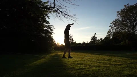 Man walking and doing tricks on slackline in the evening in backlight Stock Footage 146985961