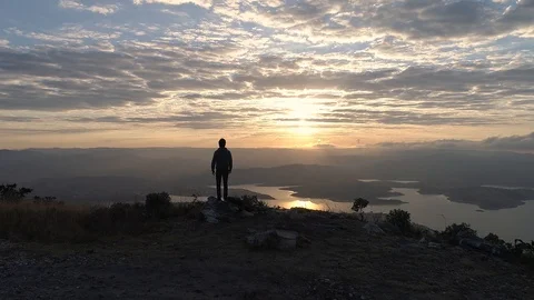Man walking and looking at sunset 動画素材 103803861