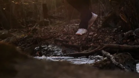 Man walking by and over flowing pond at sunset 스톡 동영상 248695538