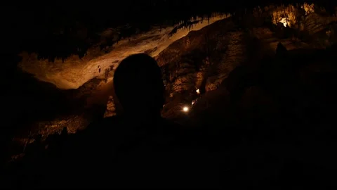 Man walking and overlooking inside cave 4K 8 Stock Footage 139982275