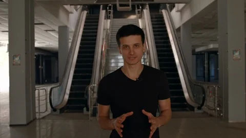 Man Walking and Talking Inside a Buidling Front-View HD Stock-Footage 92936918