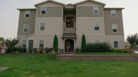 Man walking into an apartment building Stock Footage 103868560