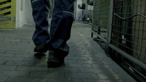 Man walking around in a factory Stock Footage 69772490