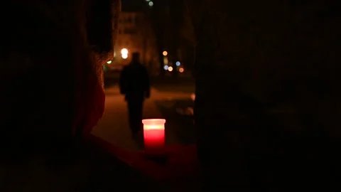 A man walking away after having lighted a candle at a memorial Stock Footage 139346799