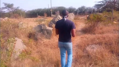 Man Walking Away Drinking Water on Hike Path Stock Footage 136989526