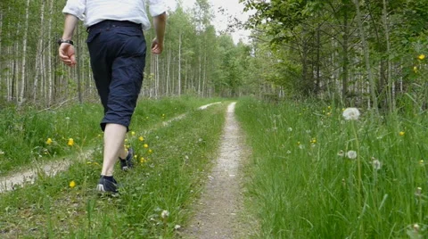 Man is walking away in the forest in slow motion Stock Footage 50059698
