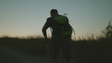 Man Walking With A Backpack And Trekking poles Early In The Morning Stock Footage 93660760