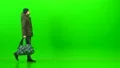 The man walking with a bag on the green background 4k or 4k+ Resolution