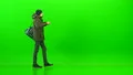 The man walking with a bag on the green background 4k or 4k+ Resolution