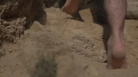 Man walking bare feet on sand with rocks. Real life urban escape concept Video stock 100188922