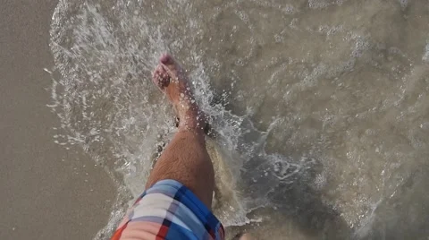 Man walking bare foot on sandy beach into ocean water. Slow motion point of view Stock-Footage 49966427
