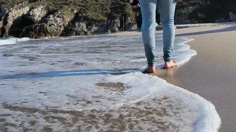 Man walking barefoot on the beach Stock Footage 239190818