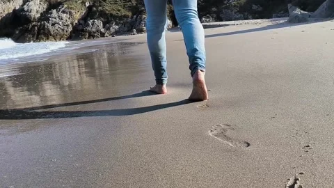 Man walking barefoot on the beach Stock Footage 239190833