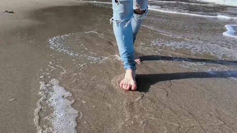 Man walking barefoot on the beach Stock Footage 239190854