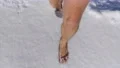 The man walking barefoot in the pure snow 4k or 4k+ Resolution