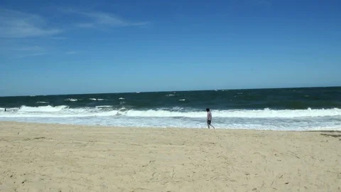 Man Walking on the Beach Alone Long Shot 動画素材 103497009