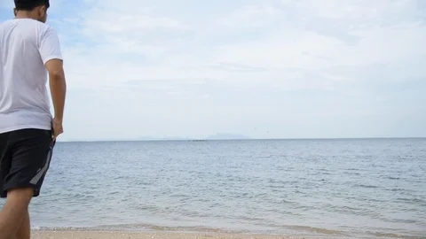 Man walking on the beach and got a call with poor signal. Telecommunication prob Stock Footage 124303896