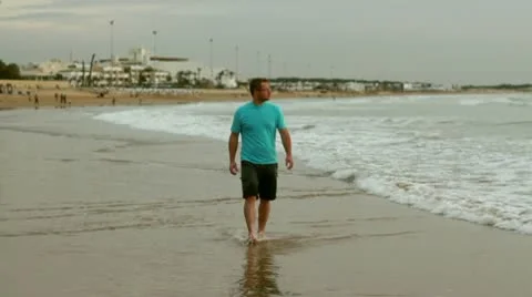 Man walking on beach and looking at the sea, slow motion 스톡 동영상 10758104