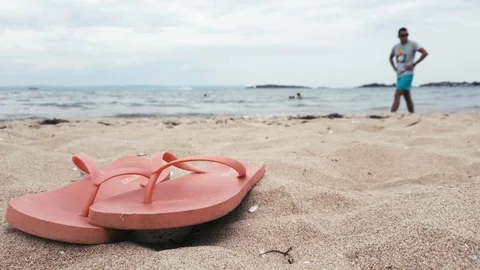Man walking on the beach and looking for something. Video stock 114303552