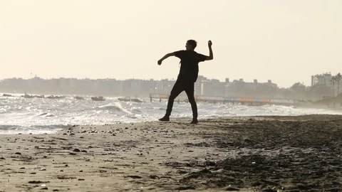 Man walking on the beach and seeing on the sea Stock Footage 98939632