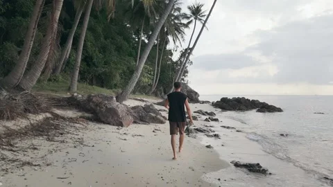 Man walking on beach back view serenity of tropical nature Man walks on beach Stock Footage 263901506