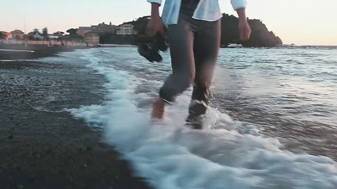 Man walking on beach with binoculars Stock Footage 81056932