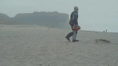 Man walking on beach Stock Footage 63464593