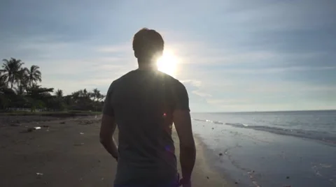 Man walking on a beach Stock Footage 65826747