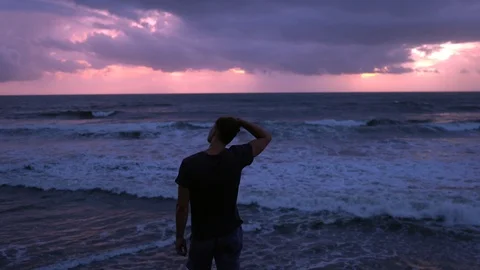 Man walking on the beach Stock Footage 125855502