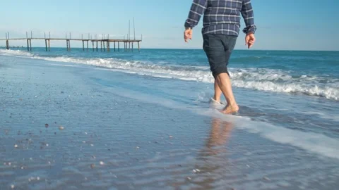 Man walking on the beach Stock Footage 168297392