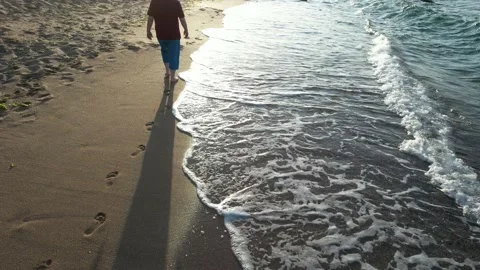 Man walking on beach Stock Footage 207222000