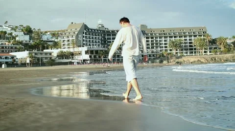Man walking on the beach HD Stock Footage 10872682