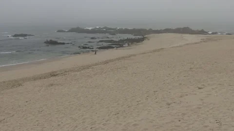 Man walking on the beach at Mindelo, along the senda litoral, Portugal Vídeo Stock 155220458