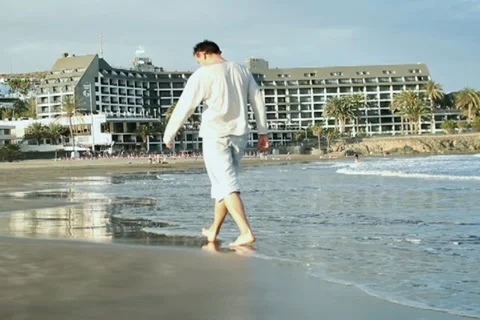 Man walking on the beach NTSC Stock Footage 10872688