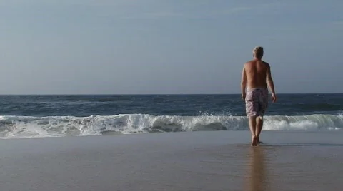 Man Walking On Beach To Ocean Stock Footage 711286