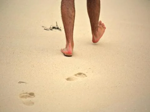 Man walking on beach Stock Photos