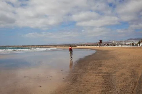 Man walking on the beach Stock Photos