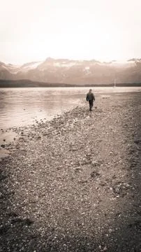 Man walking on beach Stock Photos