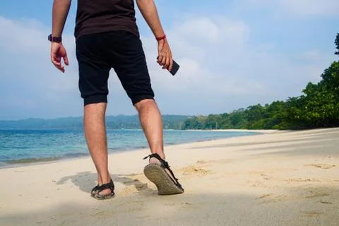Man walking on the beach. Stock Photos
