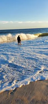 Man walking on the beach Stock Photos