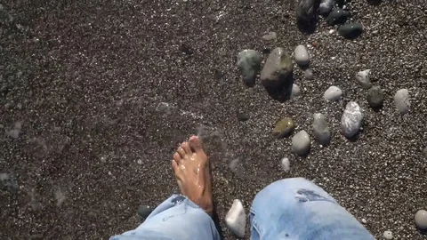 Man walking on beach with sea waves Stock Footage 93929700