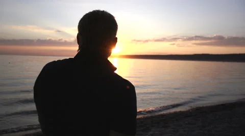Man walking on the beach in slow motion. Boy moving along the coastline. Stock Footage 67390068