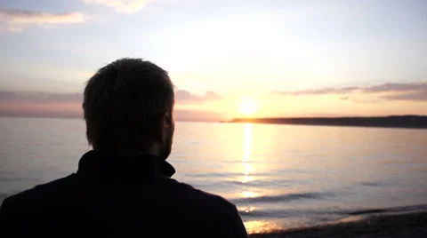 Man walking on the beach in slow motion. Boy moving along the coastline. Stock Footage 67390250