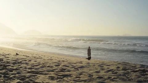 The man is walking on the beach at sunrise 스톡 동영상 81626859