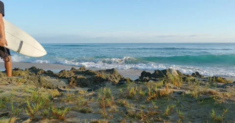 Man walking on beach with surfboard. Stock Footage 223046081