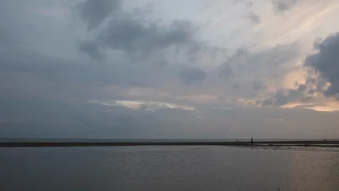 Man walking between a lagoon and the sea 스톡 동영상 103446537