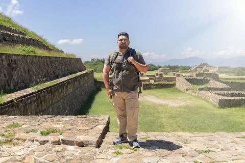 Man walking between pyramids of monte alban in oaxaca mexico 库存照片