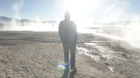 A man walking between several smoked pools in Salar de Uyuni, Bolivia Stock-Footage 125483478