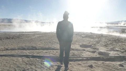 A man walking between several smoked pools in Salar de Uyuni, Bolivia Stock Footage 125483498