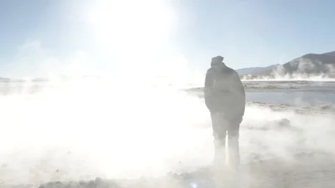 A man walking between several smoked pools in Salar de Uyuni, Bolivia Stock-Footage 125483521
